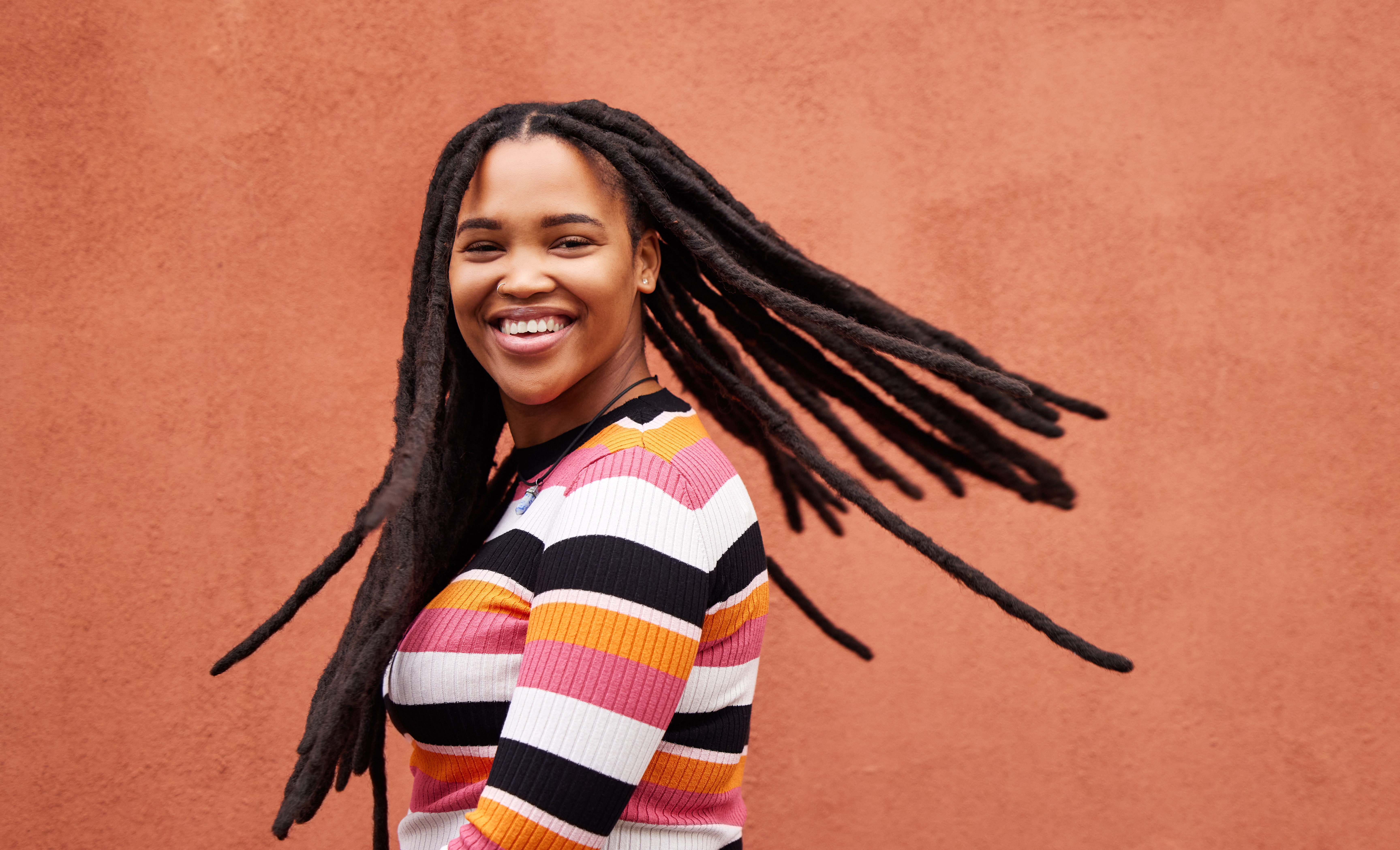 A smiling woman with dreadlocks | Source: Getty Images
