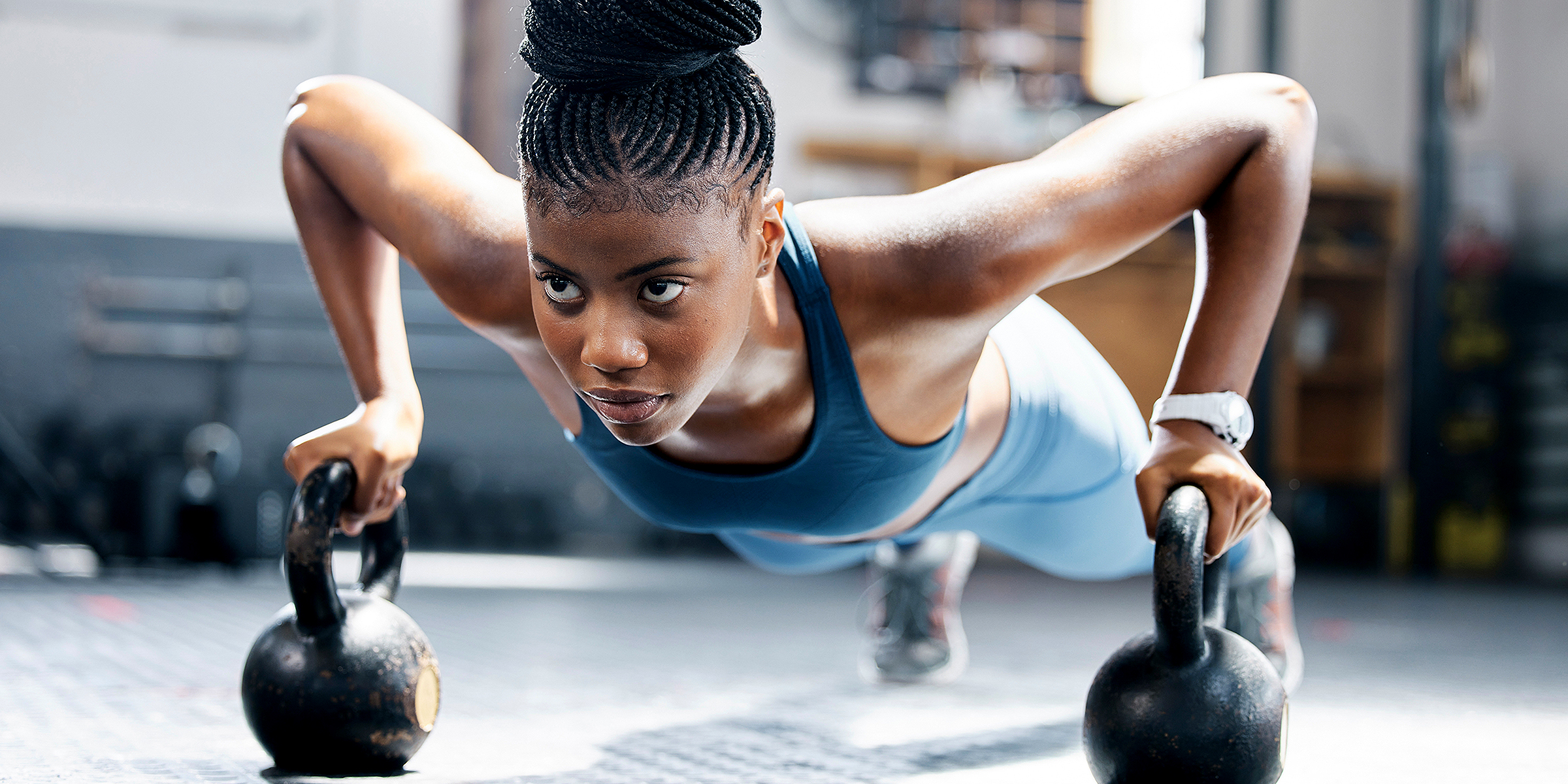 A woman using kettlebells in her workout | Source: Shutterstock