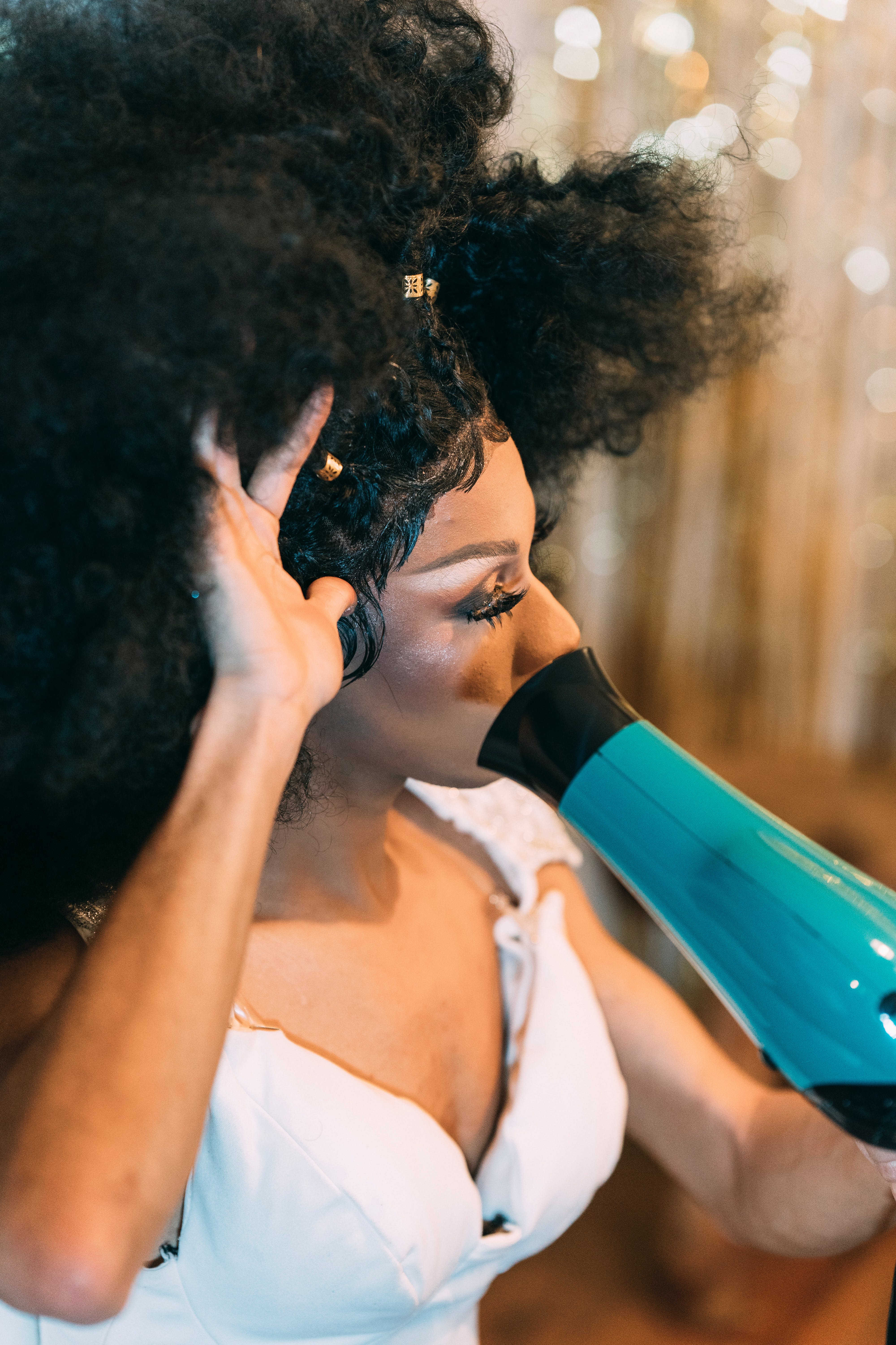 After wetting your hair, use a blow dryer on low to medium heat for effective drying. | Source: Pexels